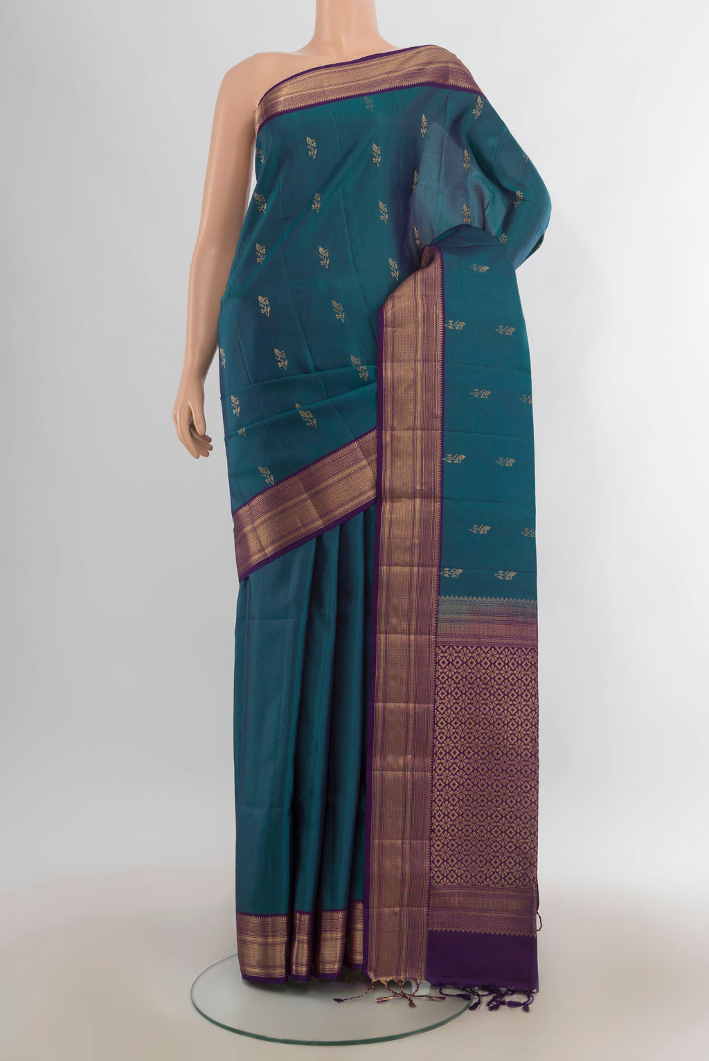 Pure Silk Peacock Blue Soft Saree with Zari Butta on the body and Zari Border.  displayed on a mannequin