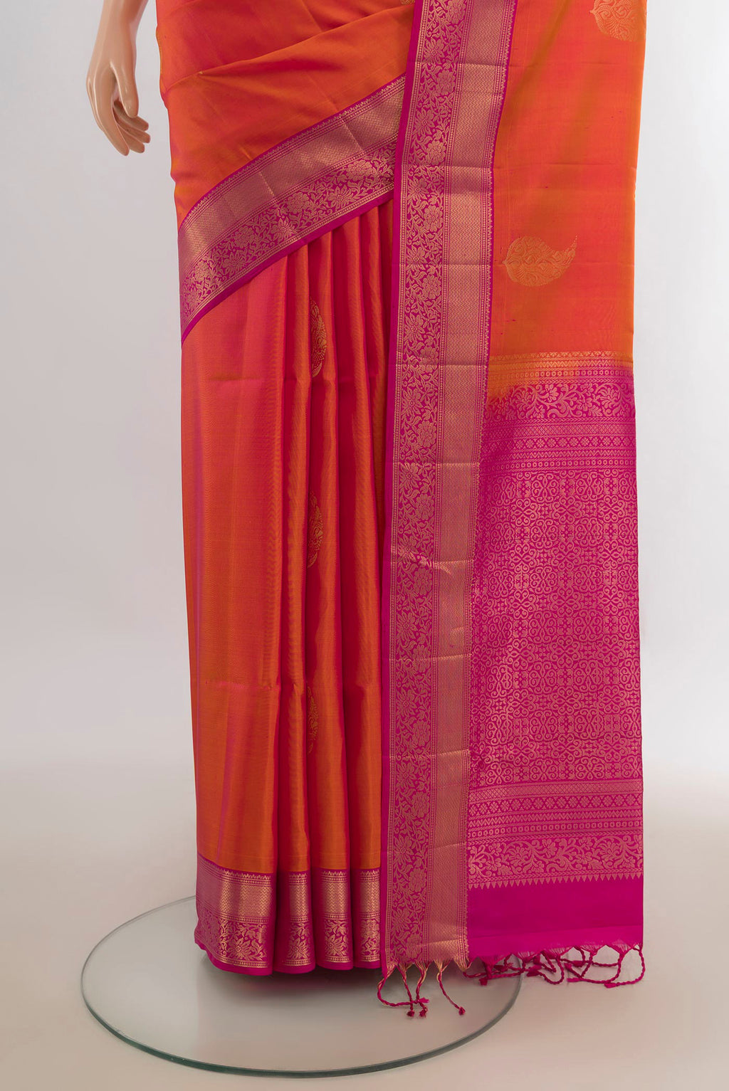 Pleats and pallu of Pure Silk Brick Orange Soft Saree with Zari Butta on the body and Zari Border. 