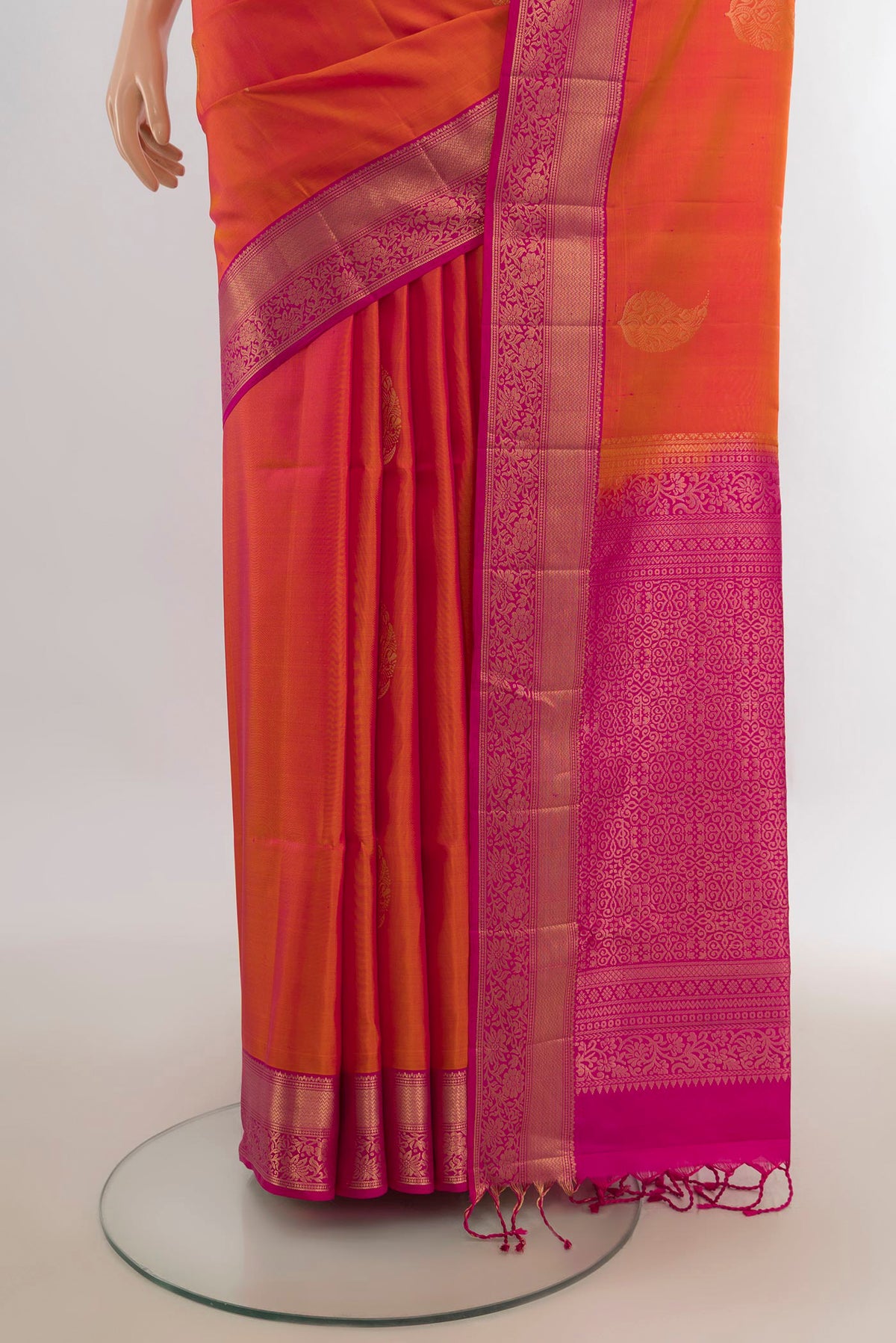 Pleats and pallu of Pure Silk Brick Orange Soft Saree with Zari Butta on the body and Zari Border. 