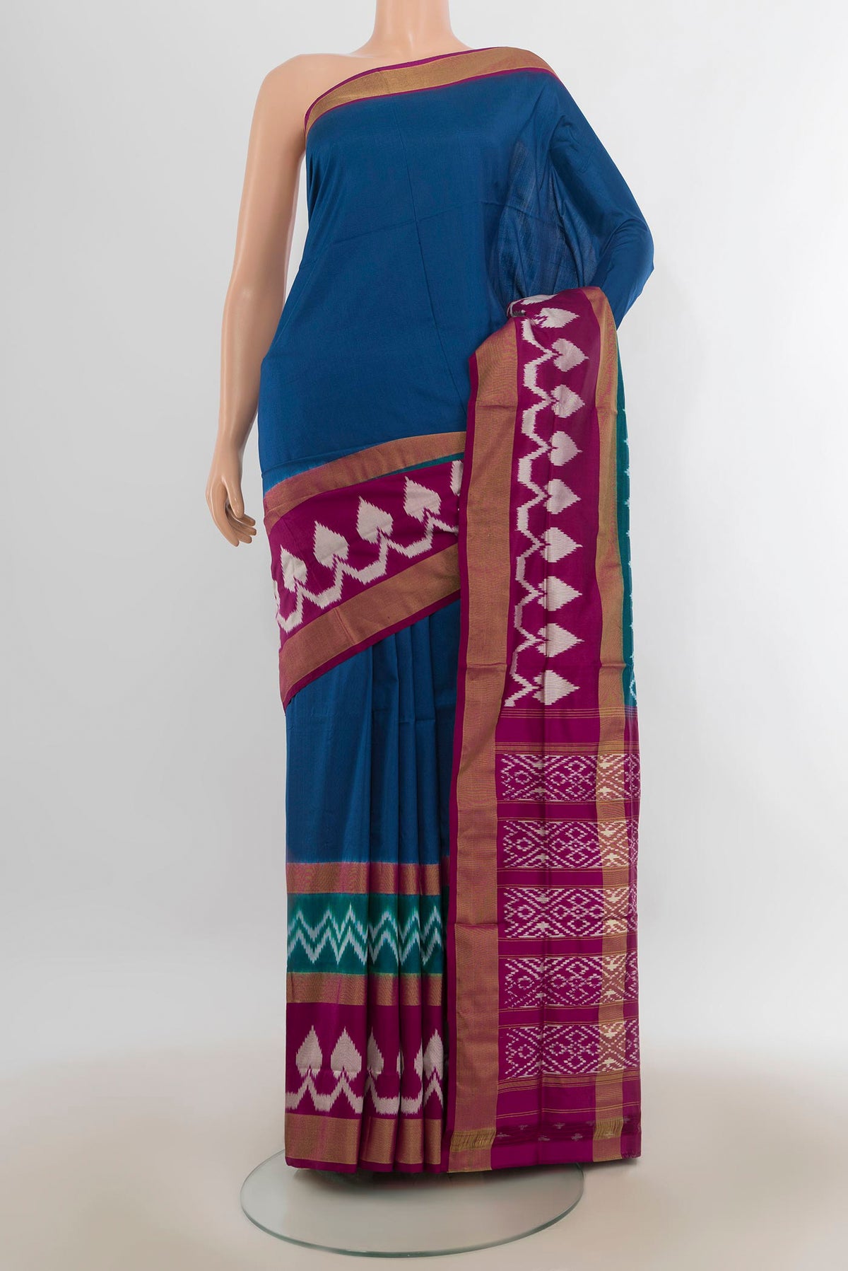 Pure Silk Peacock Blue Pochampally Saree with Plain Body and Ikat Border.  displayed on a mannequin