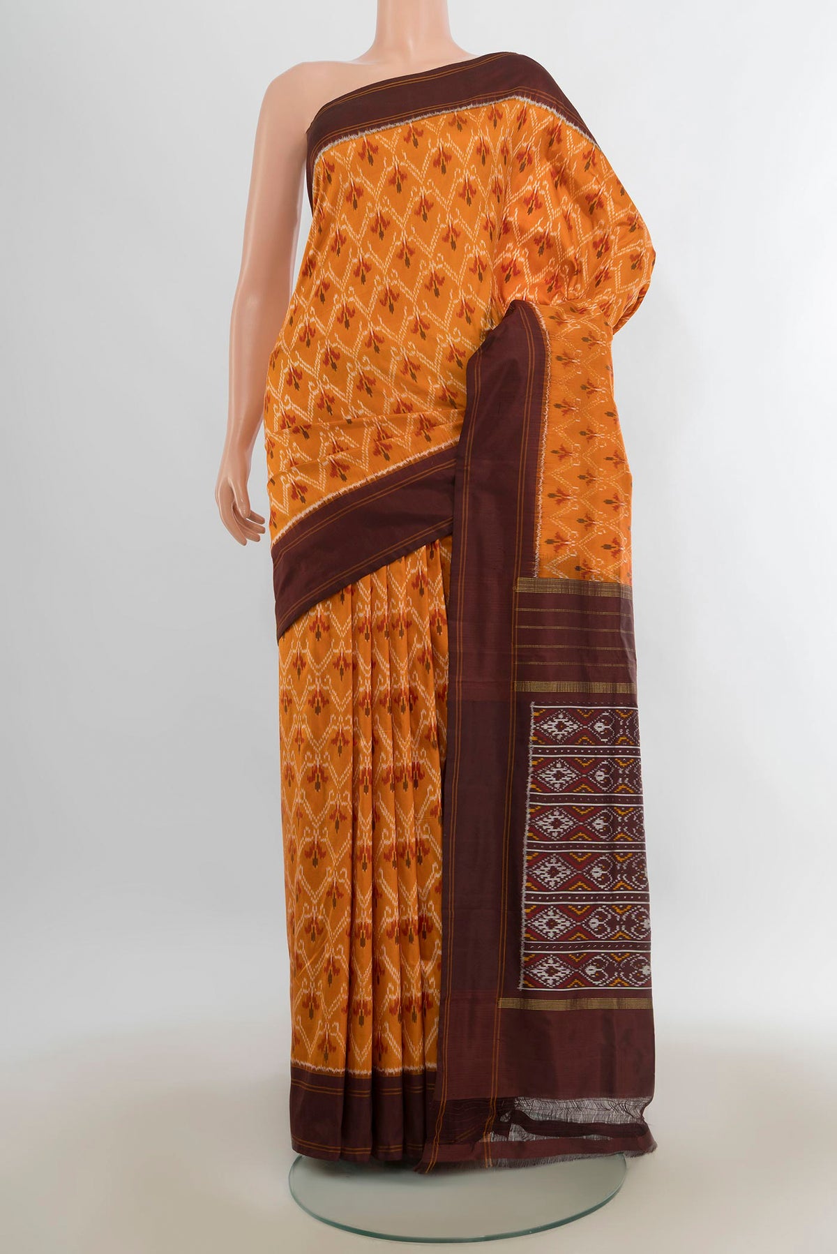 Pure Silk Orange Pochampally Saree with Pure Ikat on the body and Plain Border.  displayed on a mannequin