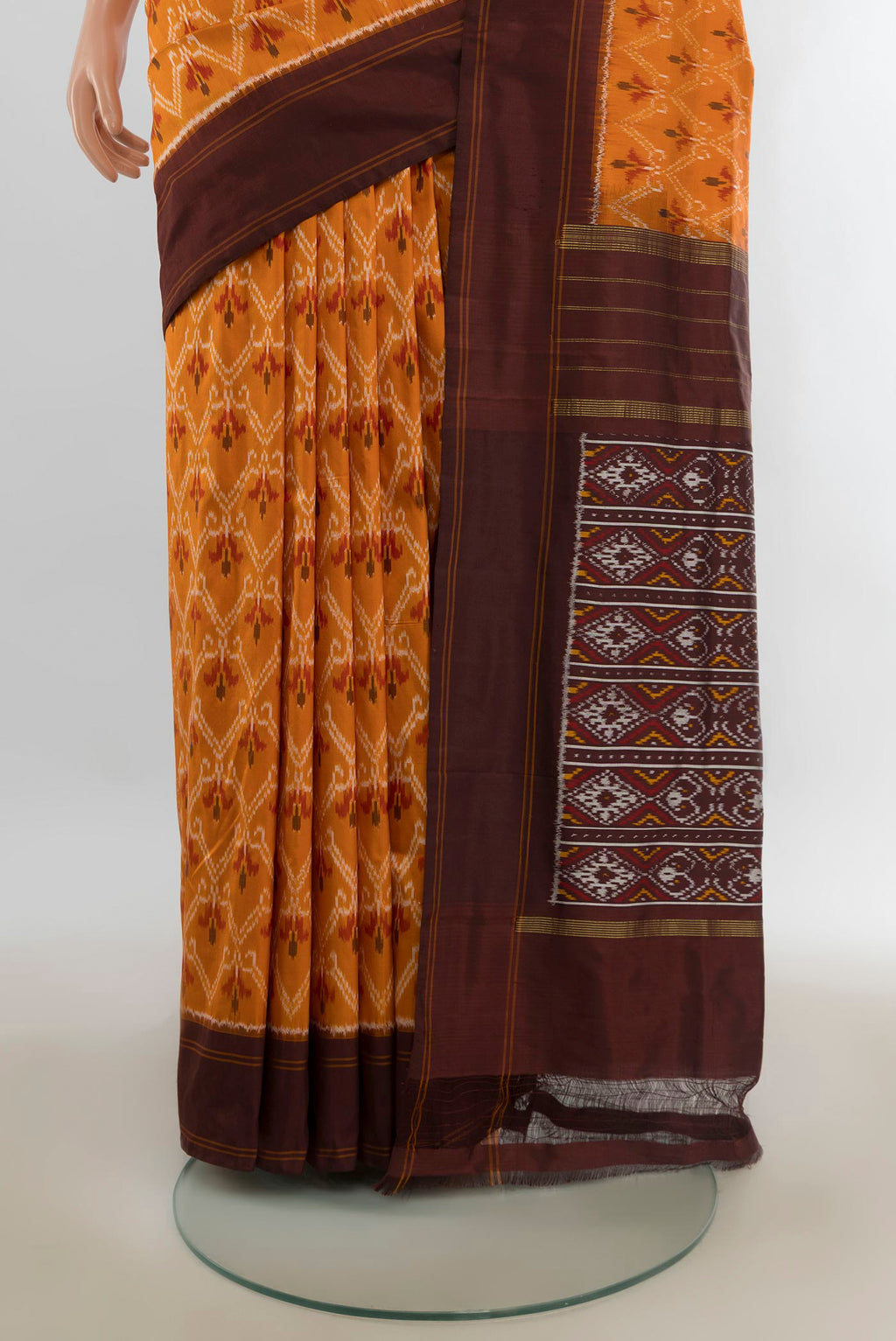 Pleats and pallu of Pure Silk Orange Pochampally Saree with Pure Ikat on the body and Plain Border. 