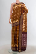 Pure Silk Brown Pochampally Saree with Pure Ikat on the body and Zari Border.  displayed on a mannequin
