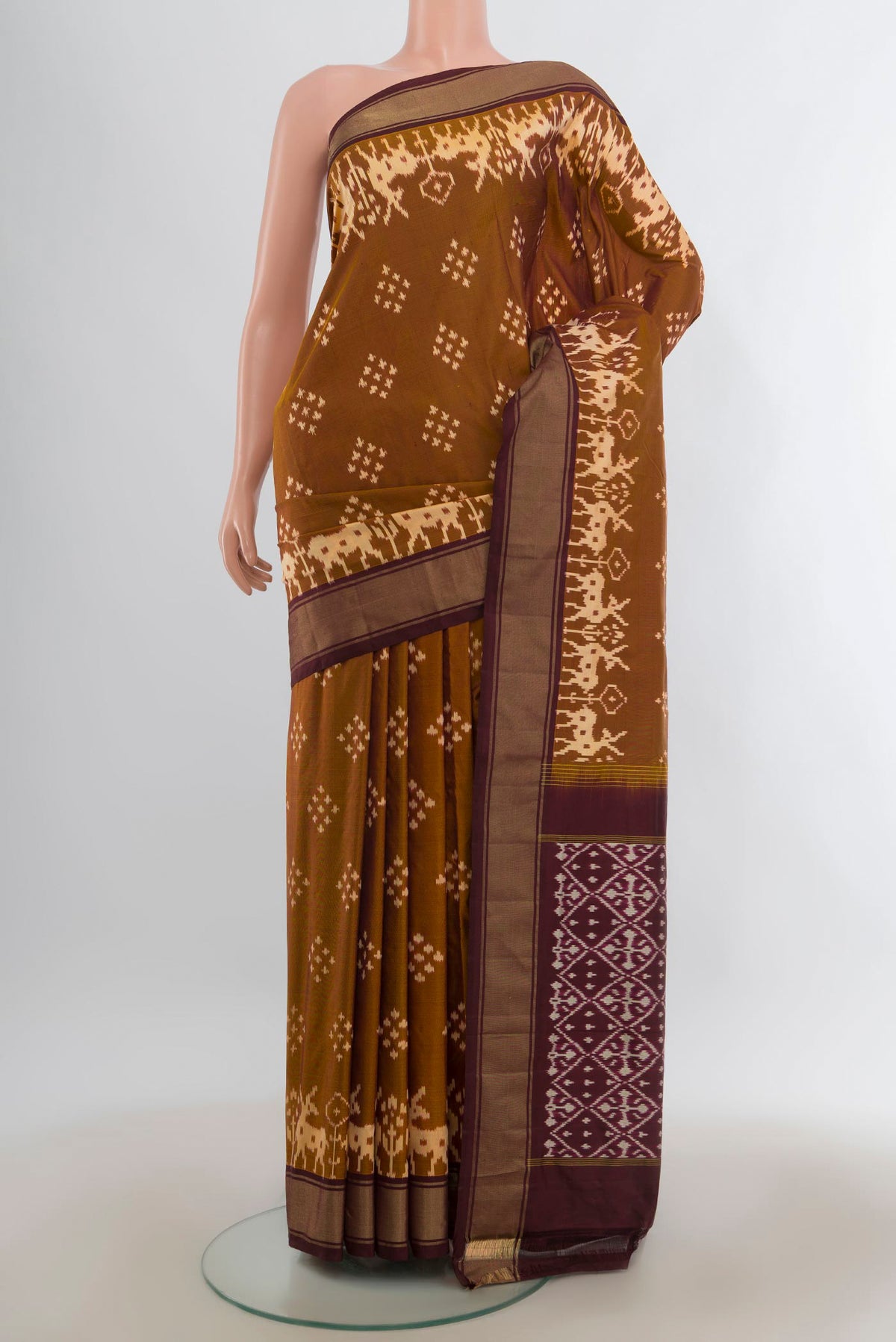 Pure Silk Brown Pochampally Saree with Pure Ikat on the body and Zari Border.  displayed on a mannequin