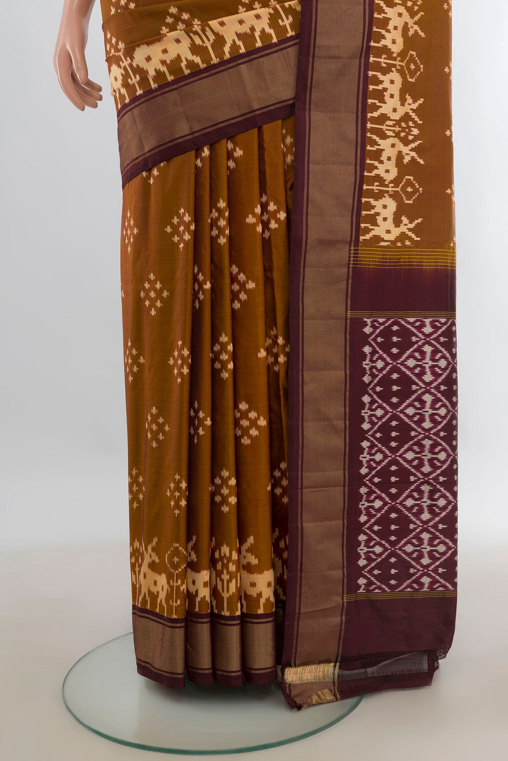 Pleats and pallu of Pure Silk Brown Pochampally Saree with Pure Ikat on the body and Zari Border. 