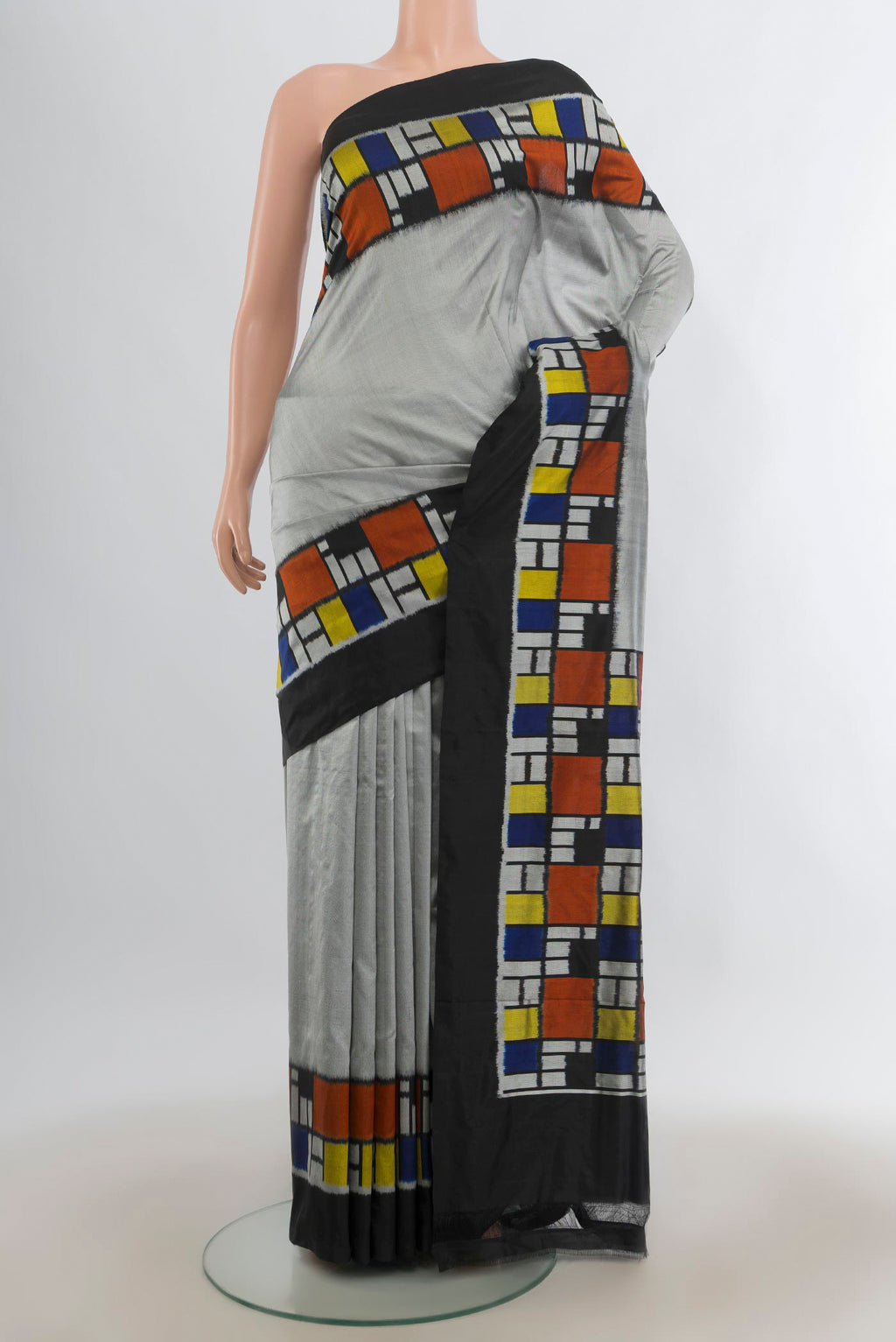 Pure Silk Grey Pochampally Saree with Plain Body and Ikat Border.  displayed on a mannequin