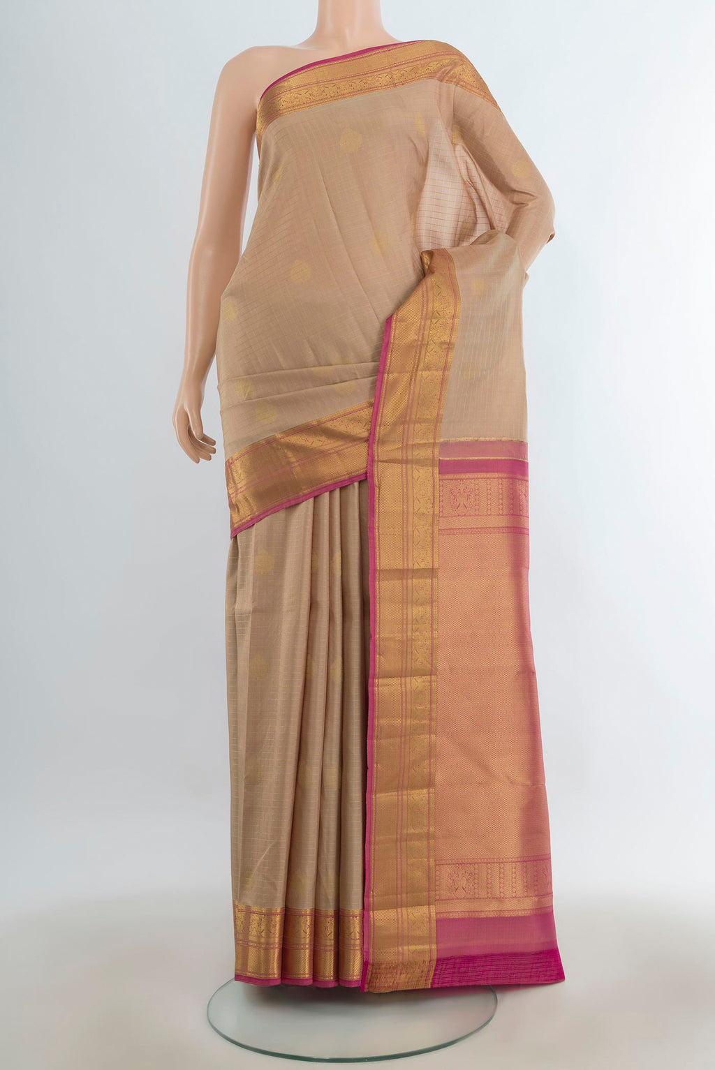 Pure Silk Sandal Kanjivaram Saree with Zari Butta on the body and Silk Border.  displayed on a mannequin