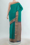 Pure Silk Turquoise Kanchipuram Saree with Zari Butta on the body and Zari Border.  displayed on a mannequin
