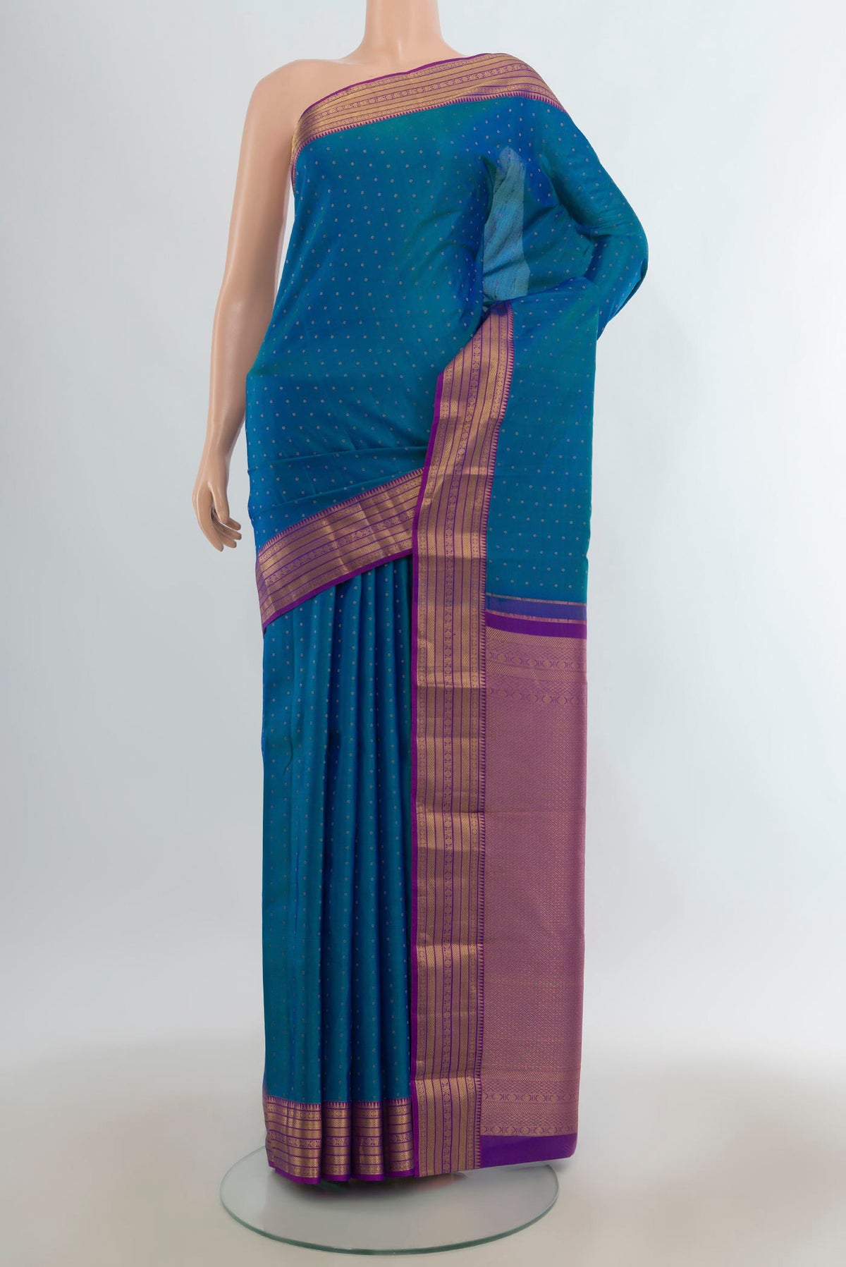 Pure Silk Peacock Blue Kanchipuram Saree with Zari Butta on the body and Zari Border.  displayed on a mannequin