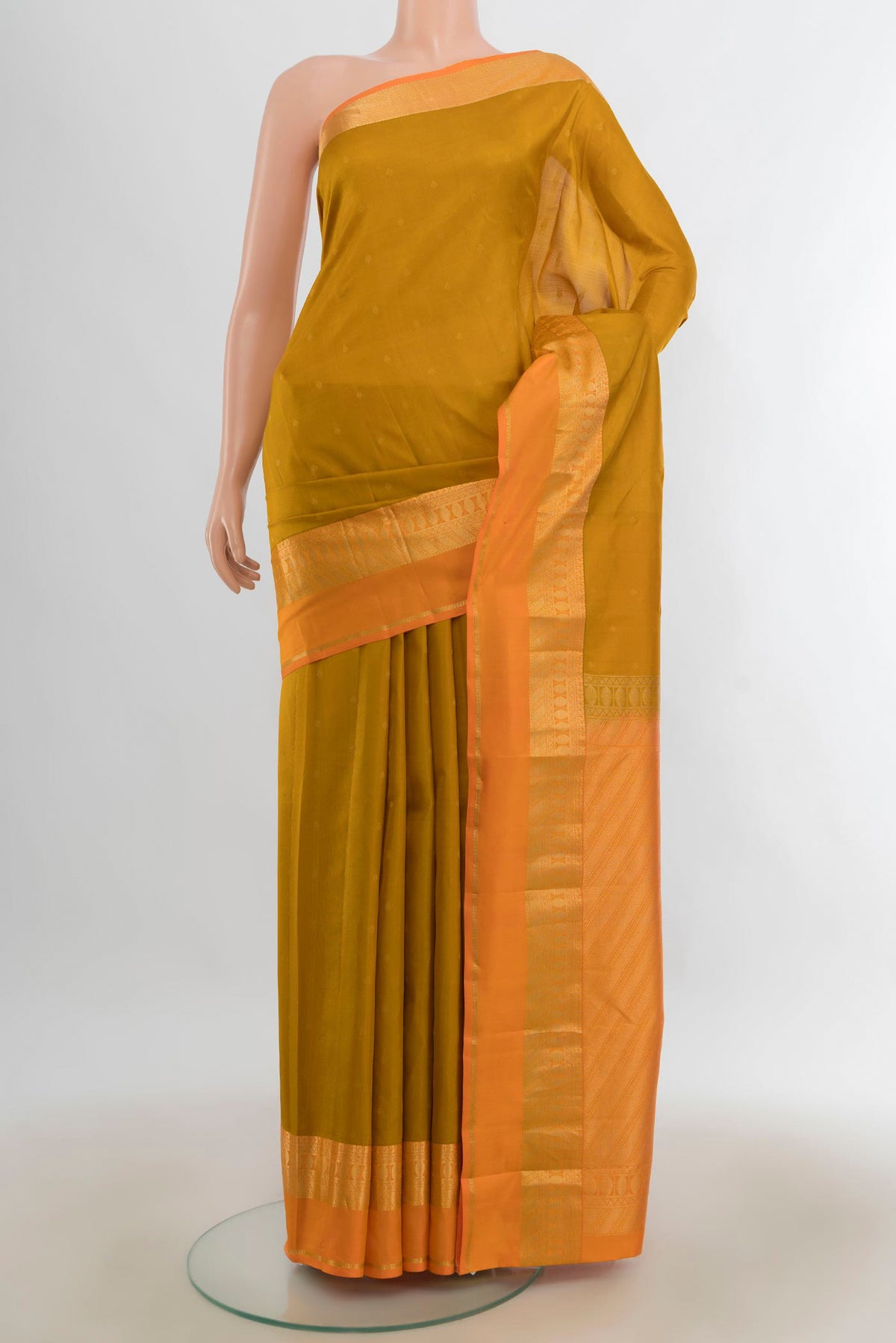 Pure Silk Mustard Kanchipuram Saree with Zari Butta on the body and Silk Border.  displayed on a mannequin