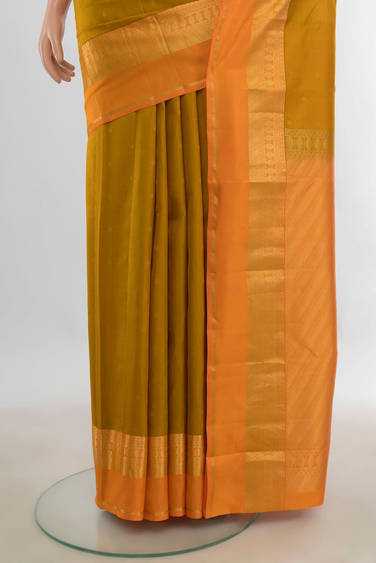 Pleats and pallu of Pure Silk Mustard Kanchipuram Saree with Zari Butta on the body and Silk Border. 