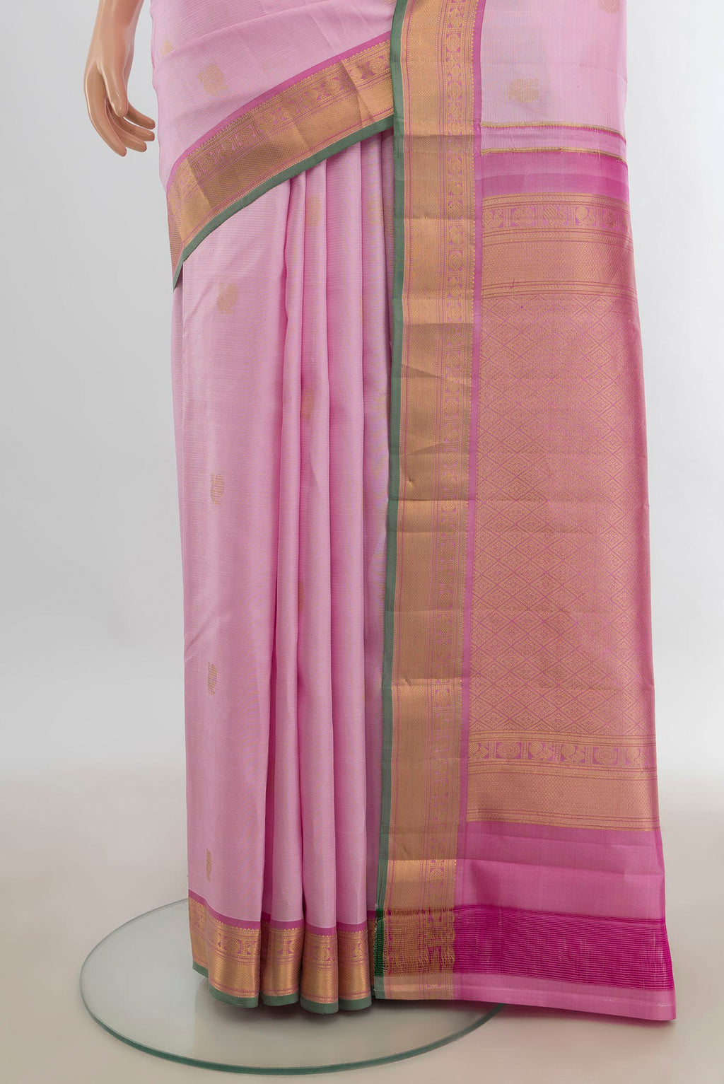 Pleats and pallu of Pure Silk Rose Gold Kanchipuram Saree with Zari Butta on the body and Silk Border. 