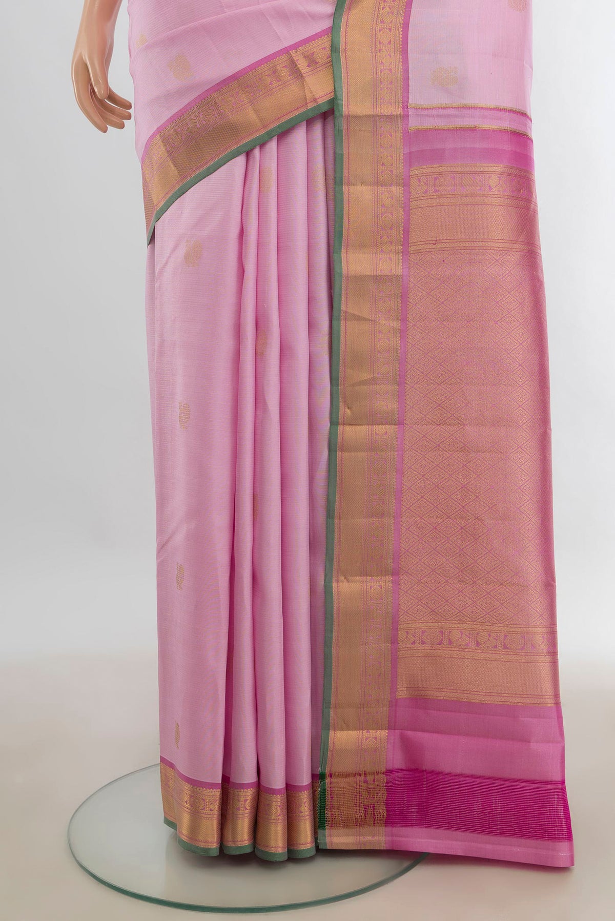 Pleats and pallu of Pure Silk Rose Gold Kanchipuram Saree with Zari Butta on the body and Silk Border. 