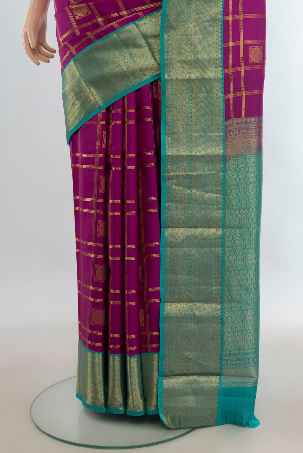 Pleats and pallu of Pure Silk Magenta Kanchipuram Saree with Checked design on the body and Zari Border. 