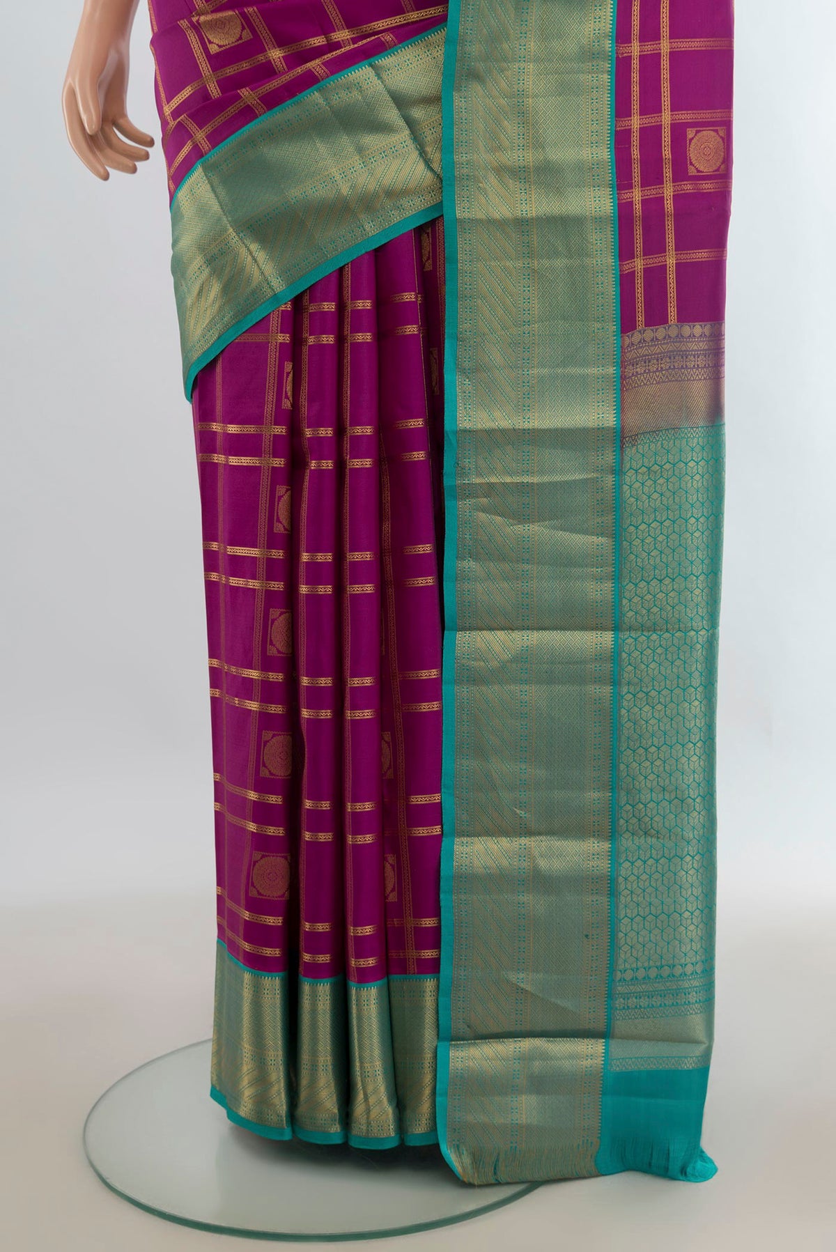 Pleats and pallu of Pure Silk Magenta Kanchipuram Saree with Checked design on the body and Zari Border. 