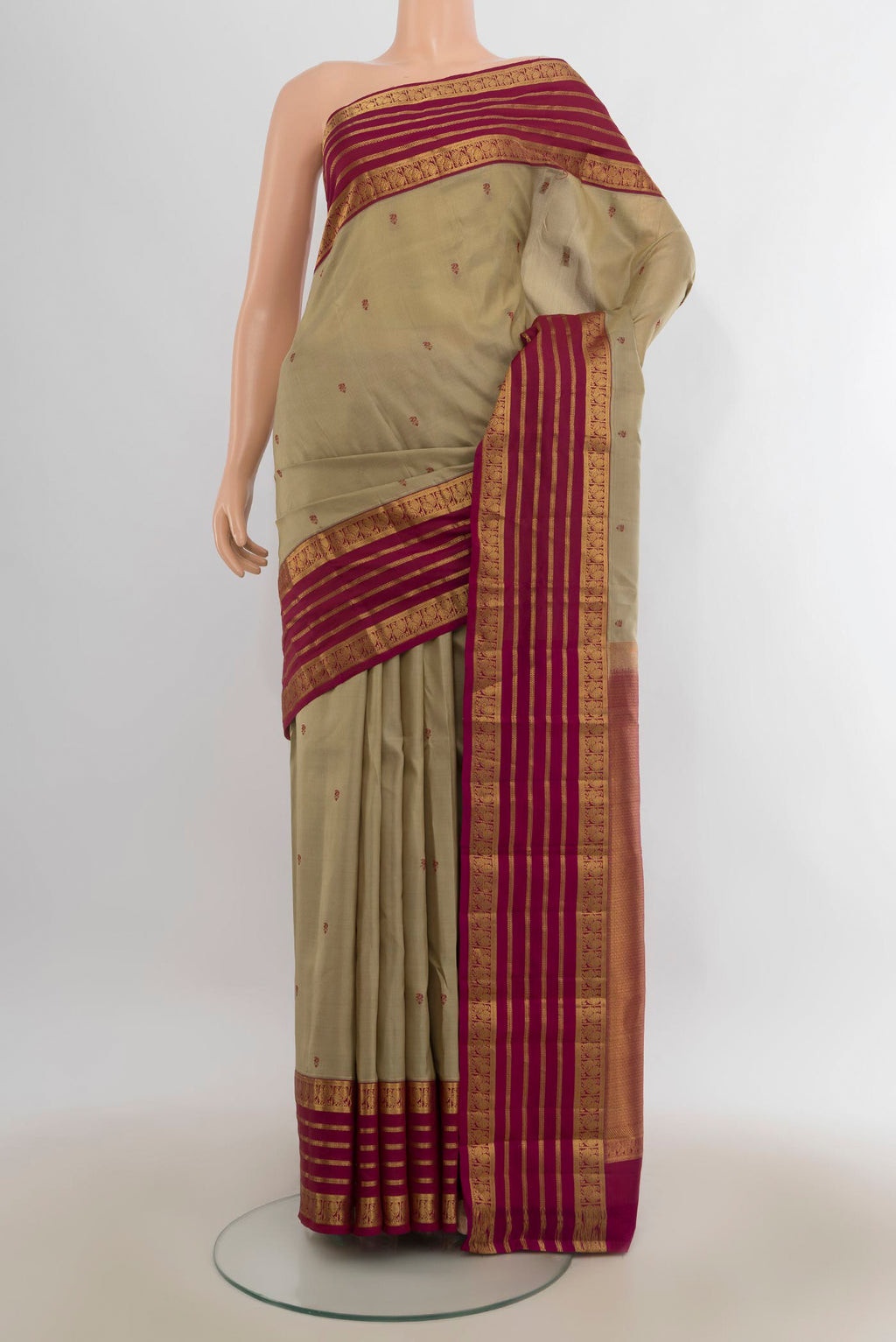 Pure Silk Dark Beige Kanjivaram Saree with Thread Butta on the body and Zari Border.  displayed on a mannequin
