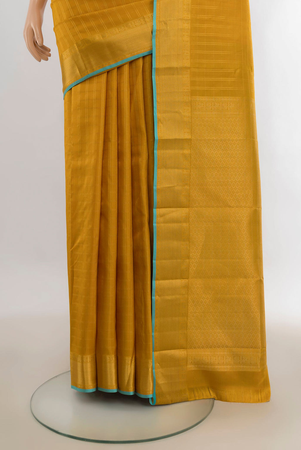 Pleats and pallu of Pure Silk Mustard Kanchipuram Saree with Checked design on the body and Zari Border. 