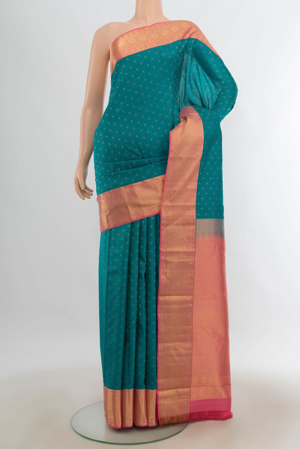 Pure Silk Peacock Blue Kanjivaram Saree with Zari Butta on the body and Silk Border.  displayed on a mannequin