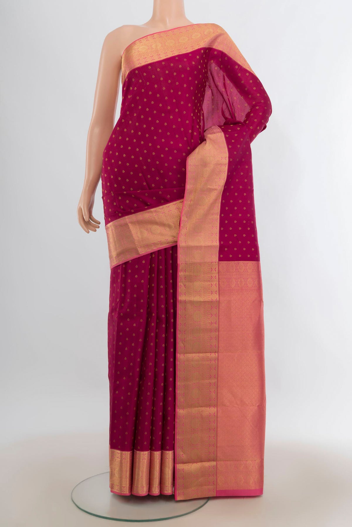 Pure Silk Maroon Kanjivaram Saree with Zari Butta on the body and Zari Border.  displayed on a mannequin