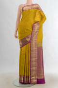 Pure Silk Mustard Kanjivaram Saree with Zari Butta on the body and Silk Border.  displayed on a mannequin