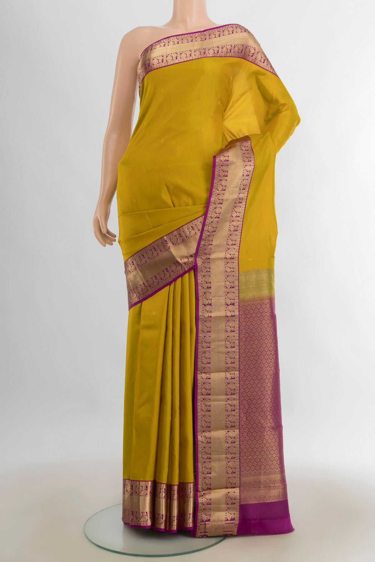 Pure Silk Mustard Kanjivaram Saree with Zari Butta on the body and Silk Border.  displayed on a mannequin