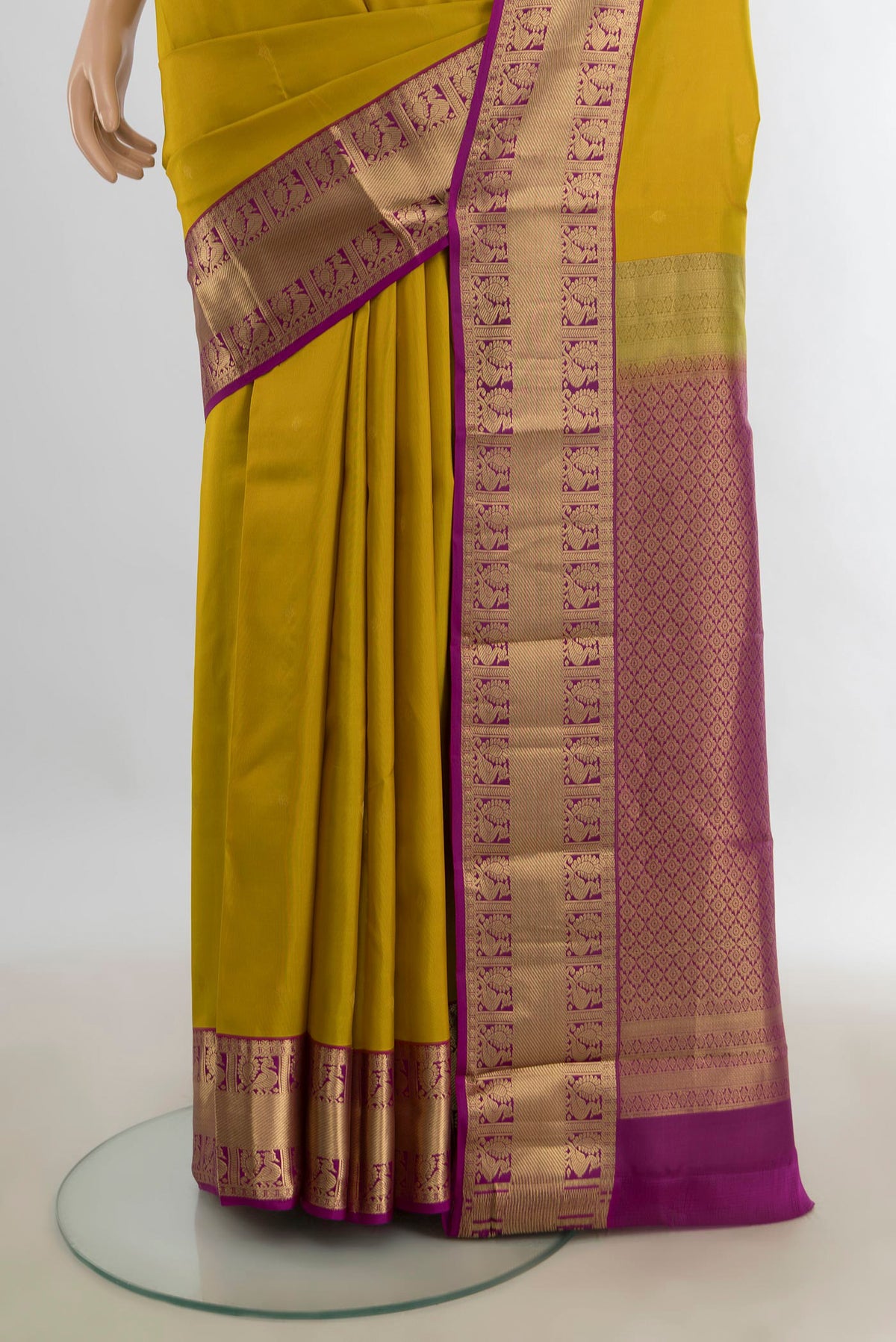 Pleats and pallu of Pure Silk Mustard Kanjivaram Saree with Zari Butta on the body and Silk Border. 