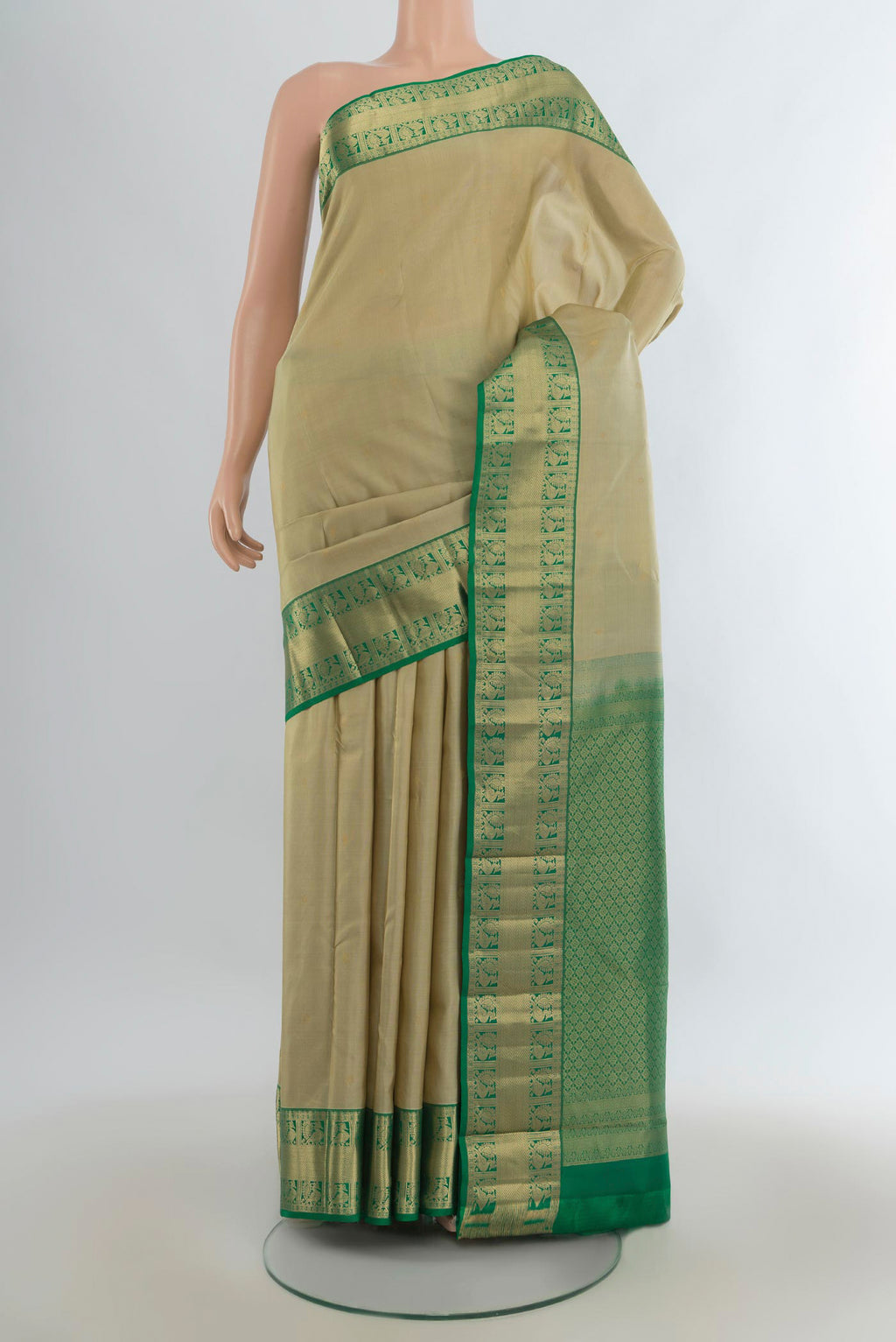Pure Silk Beige Kanjivaram Saree with Zari Butta on the body and Zari Border.  displayed on a mannequin