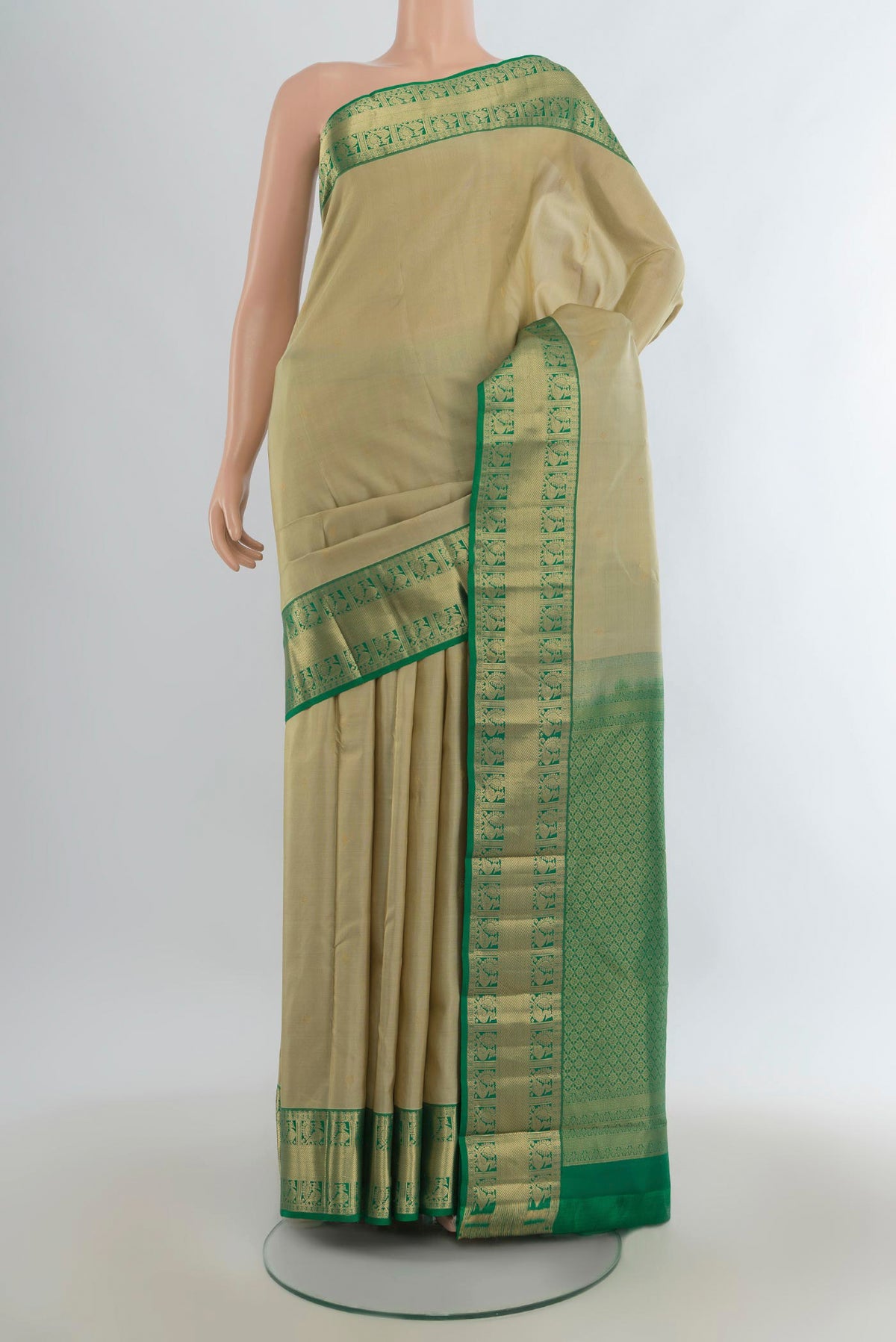 Pure Silk Beige Kanjivaram Saree with Zari Butta on the body and Zari Border.  displayed on a mannequin
