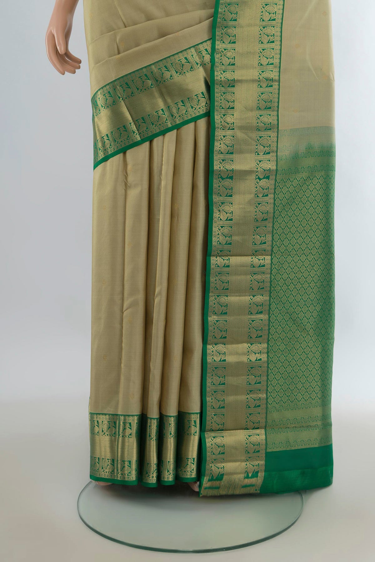 Pleats and pallu of Pure Silk Beige Kanjivaram Saree with Zari Butta on the body and Zari Border. 