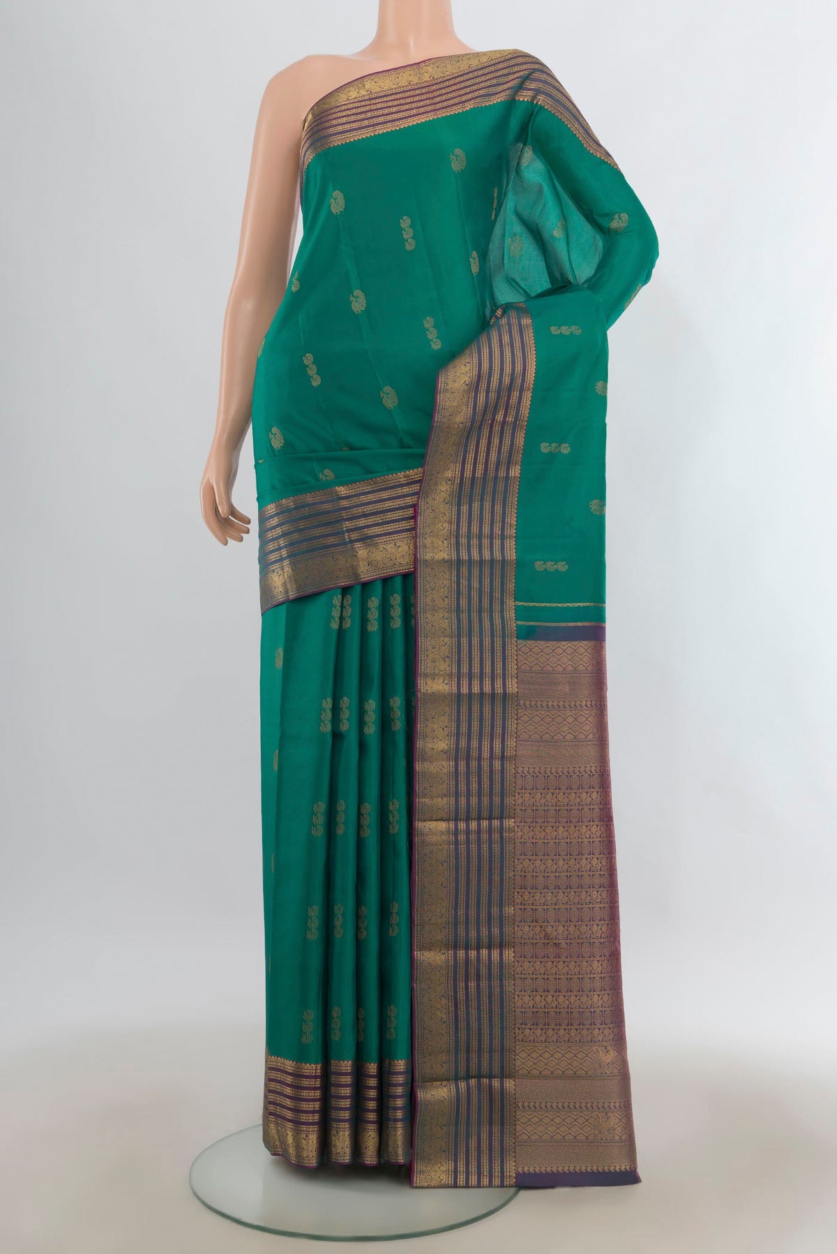 Pure Silk Green Kanchipuram Saree with Zari Butta on the body and Zari Border.  displayed on a mannequin