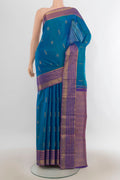 Pure Silk Peacock Blue Kanchipuram Saree with Zari Butta on the body and Zari Border.  displayed on a mannequin