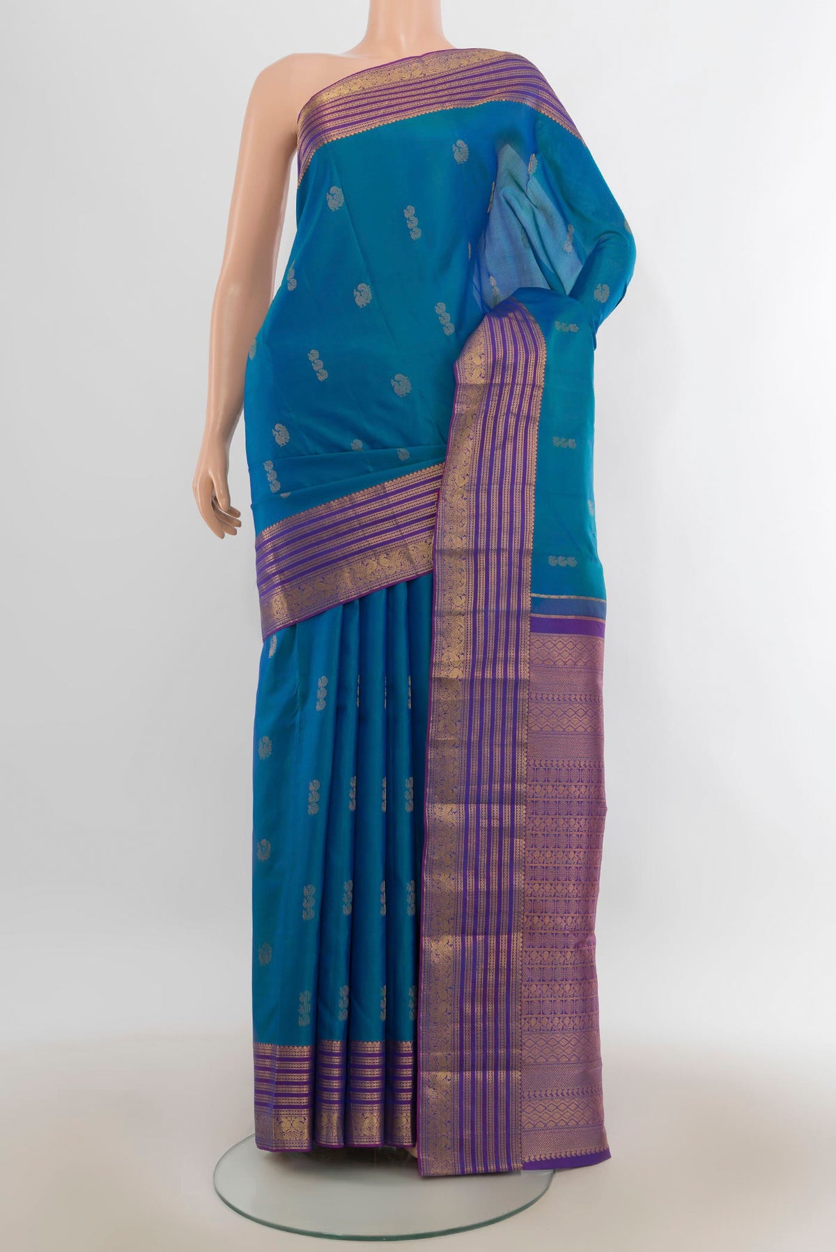 Pure Silk Peacock Blue Kanchipuram Saree with Zari Butta on the body and Zari Border.  displayed on a mannequin
