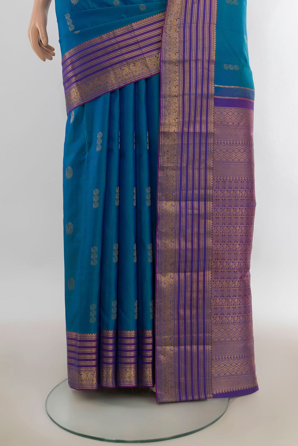 Pleats and pallu of Pure Silk Peacock Blue Kanchipuram Saree with Zari Butta on the body and Zari Border. 