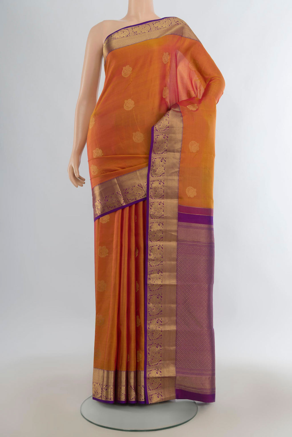 Pure Silk Mustard Kanjivaram Saree with Zari Butta on the body and Zari Border.  displayed on a mannequin