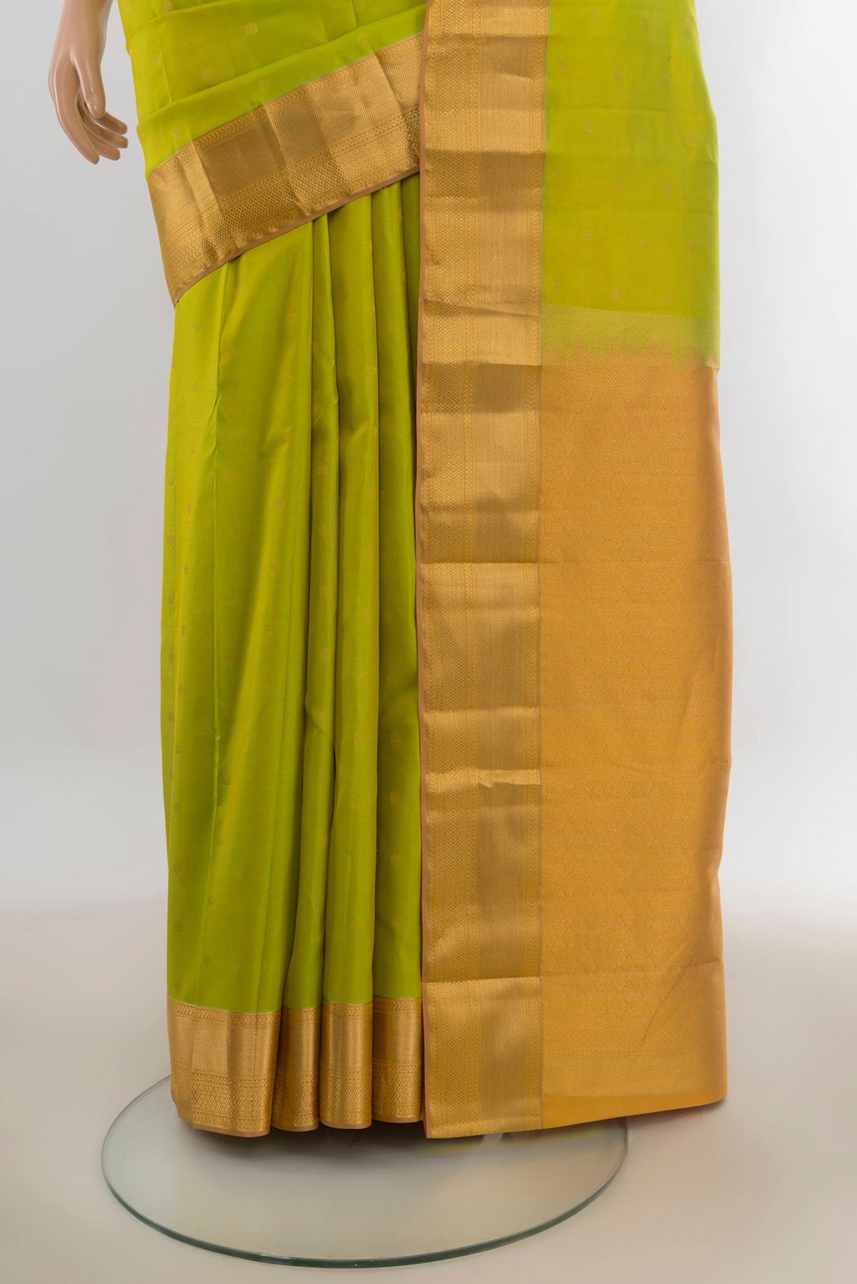 Pleats and pallu of Pure Silk Parrot Green Kanchipuram Saree with Zari Butta on the body and Zari Border. 