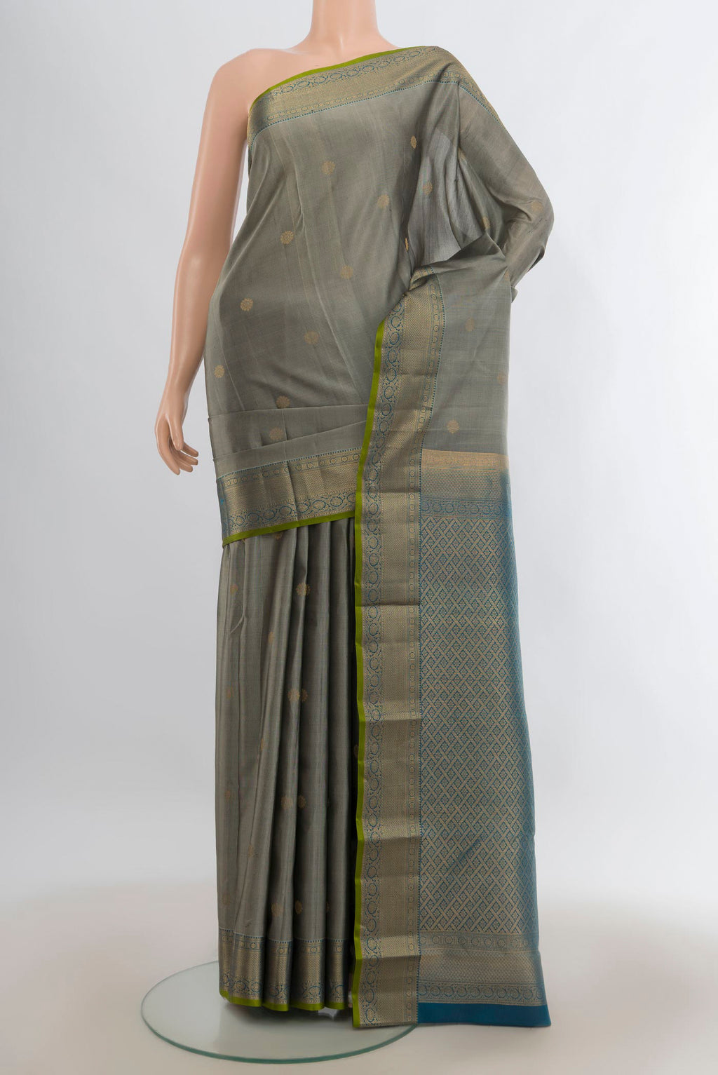 Pure Silk Grey Kanjivaram Saree with Zari Butta on the body and Zari Border.  displayed on a mannequin