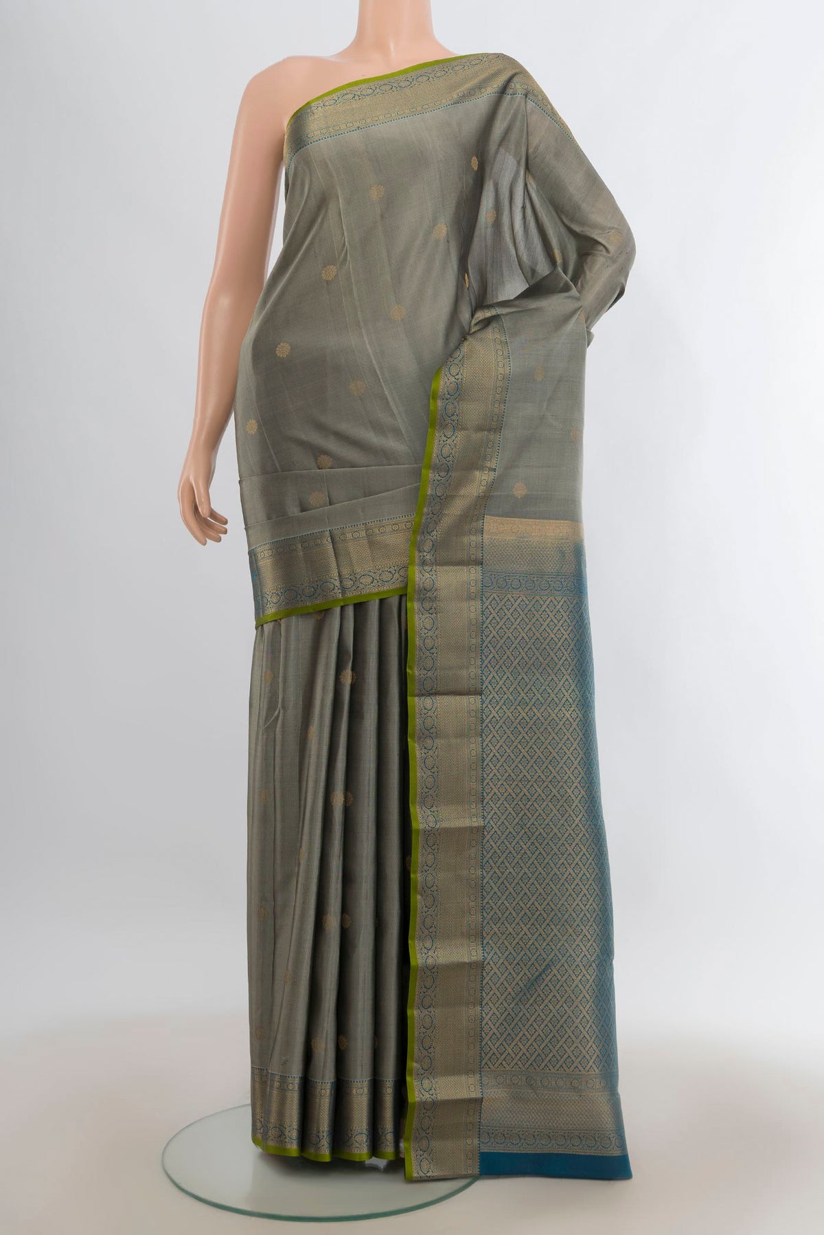 Pure Silk Grey Kanjivaram Saree with Zari Butta on the body and Zari Border.  displayed on a mannequin