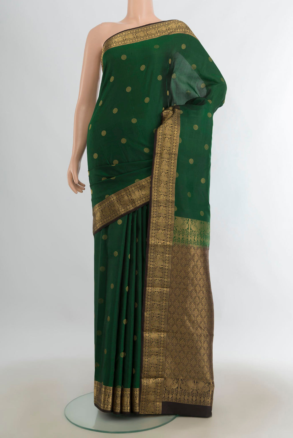 Pure Silk Mint Green Kanchipuram Saree with Zari Butta on the body and Silk Border.  displayed on a mannequin