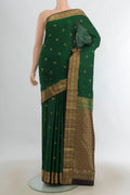 Pure Silk Mint Green Kanchipuram Saree with Zari Butta on the body and Silk Border.  displayed on a mannequin