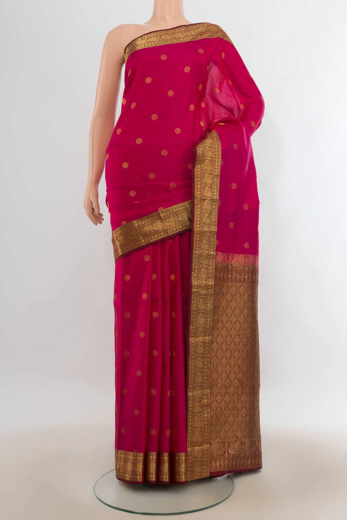 Pure Silk Dark Pink Kanchipuram Saree with Zari Butta on the body and Zari Border.  displayed on a mannequin