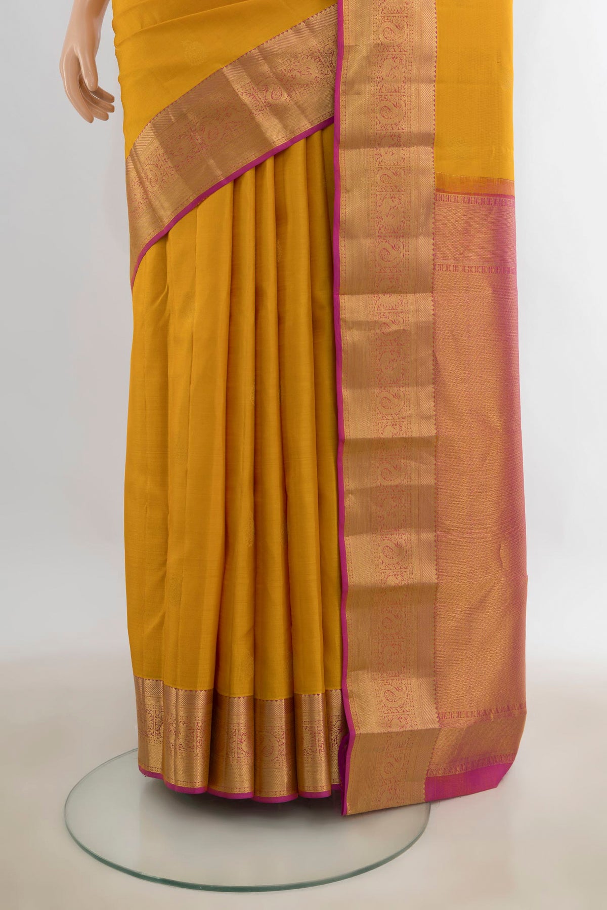 Pleats and pallu of Pure Silk Mustard Kanjivaram Saree with Zari Butta on the body and Zari Border. 