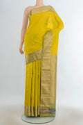 Pure Silk Light Green Kanjivaram Saree with Zari Butta on the body and Silk Border.  displayed on a mannequin