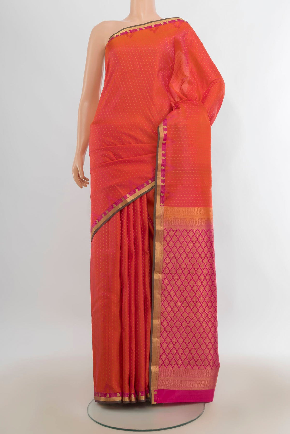 Pure Silk Brick Orange Dual Tone Kanchipuram Saree with Zari Butta on the body and Zari Border.  displayed on a mannequin