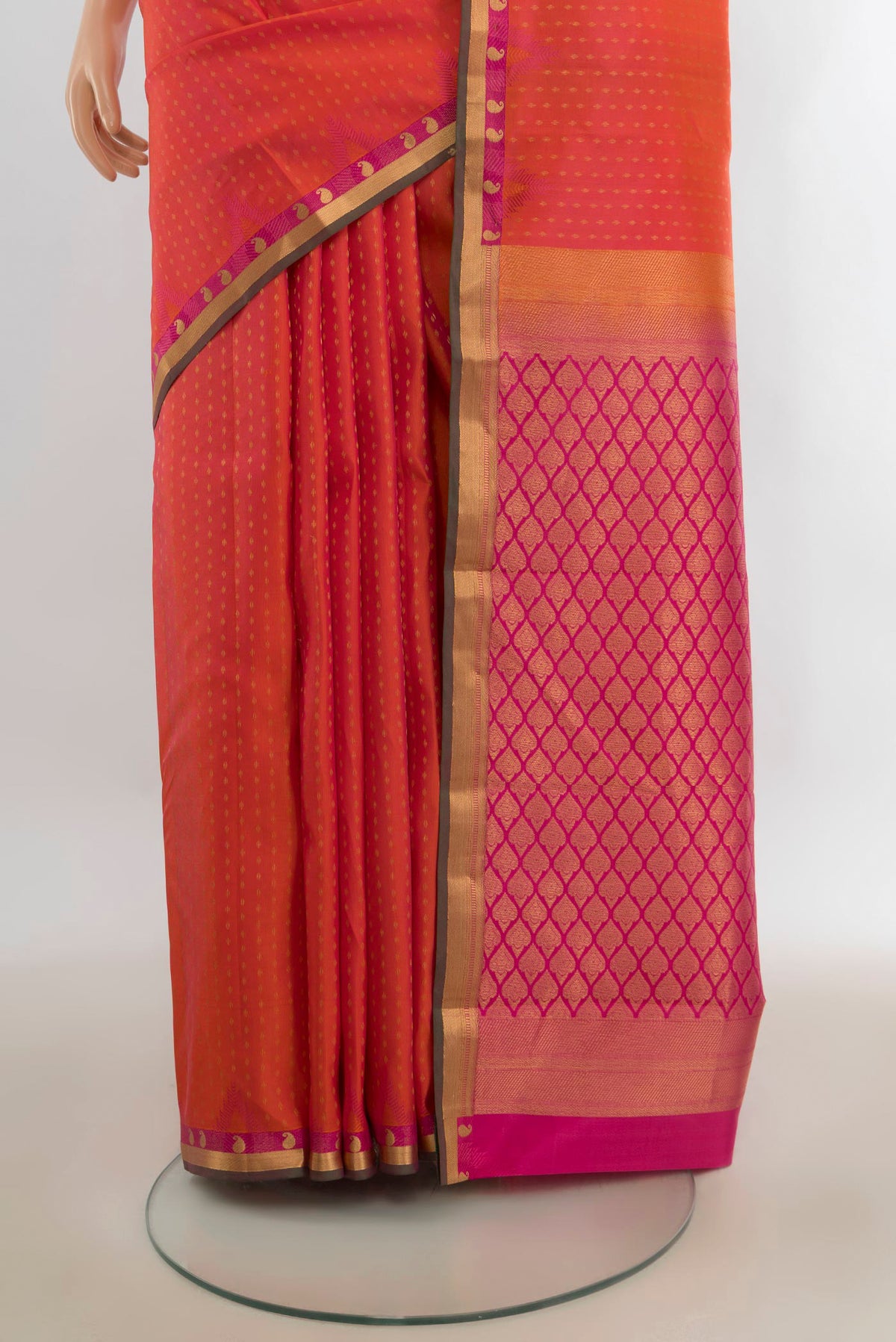 Pleats and pallu of Pure Silk Brick Orange Dual Tone Kanchipuram Saree with Zari Butta on the body and Zari Border. 