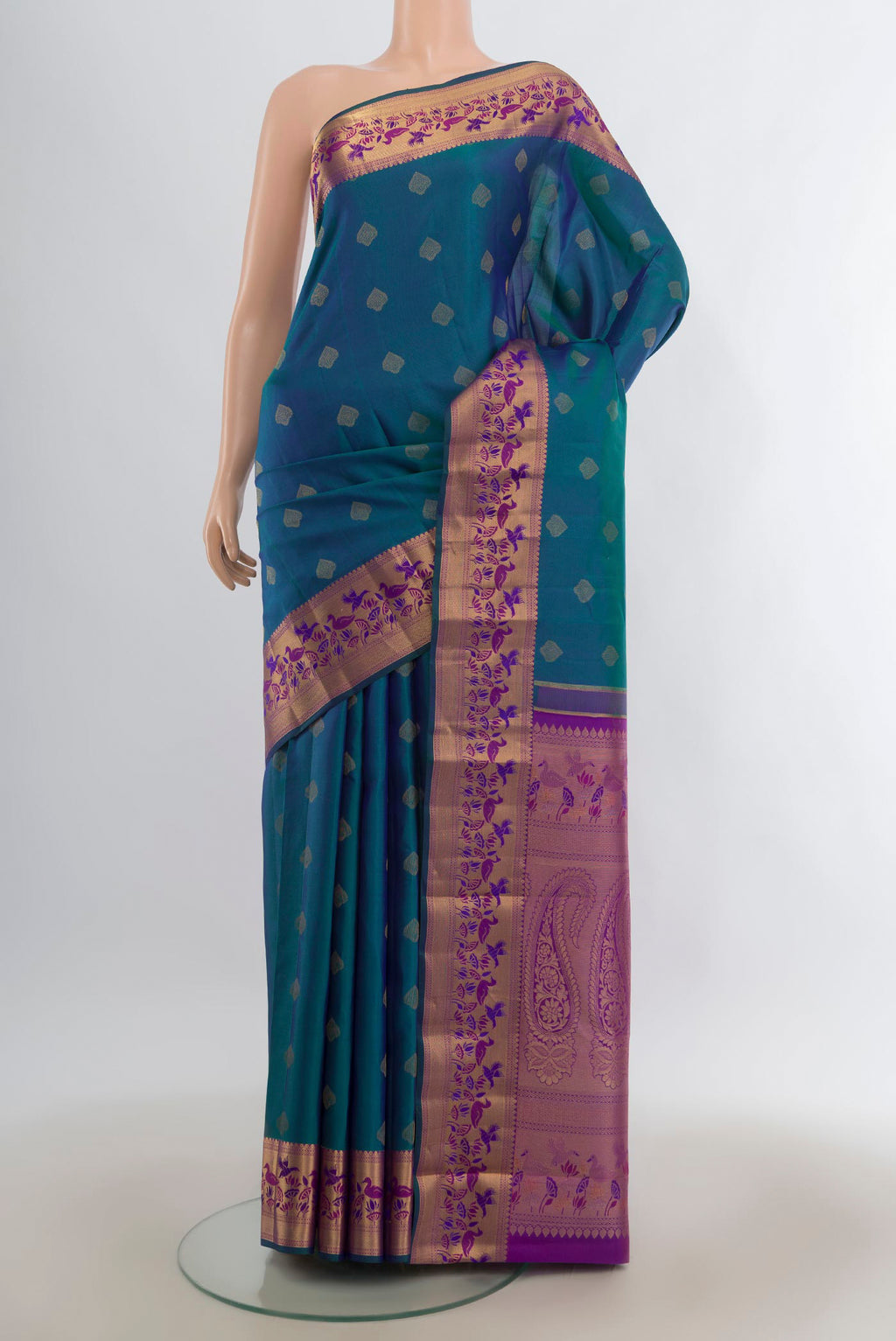 Pure Silk Peacock Blue Kanjivaram Saree with Zari Butta on the body and Zari Border.  displayed on a mannequin