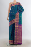 Pure Silk Peacock Blue Kanjivaram Saree with Zari Butta on the body and Zari Border.  displayed on a mannequin