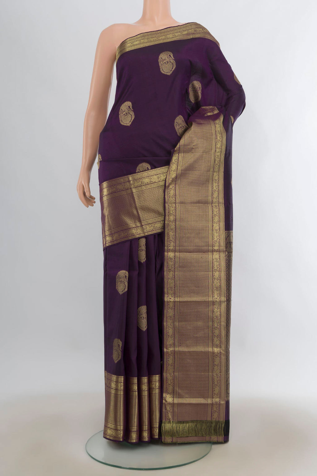 Pure Silk Purple Kanjivaram Saree with Zari Butta on the body and Zari Border.  displayed on a mannequin
