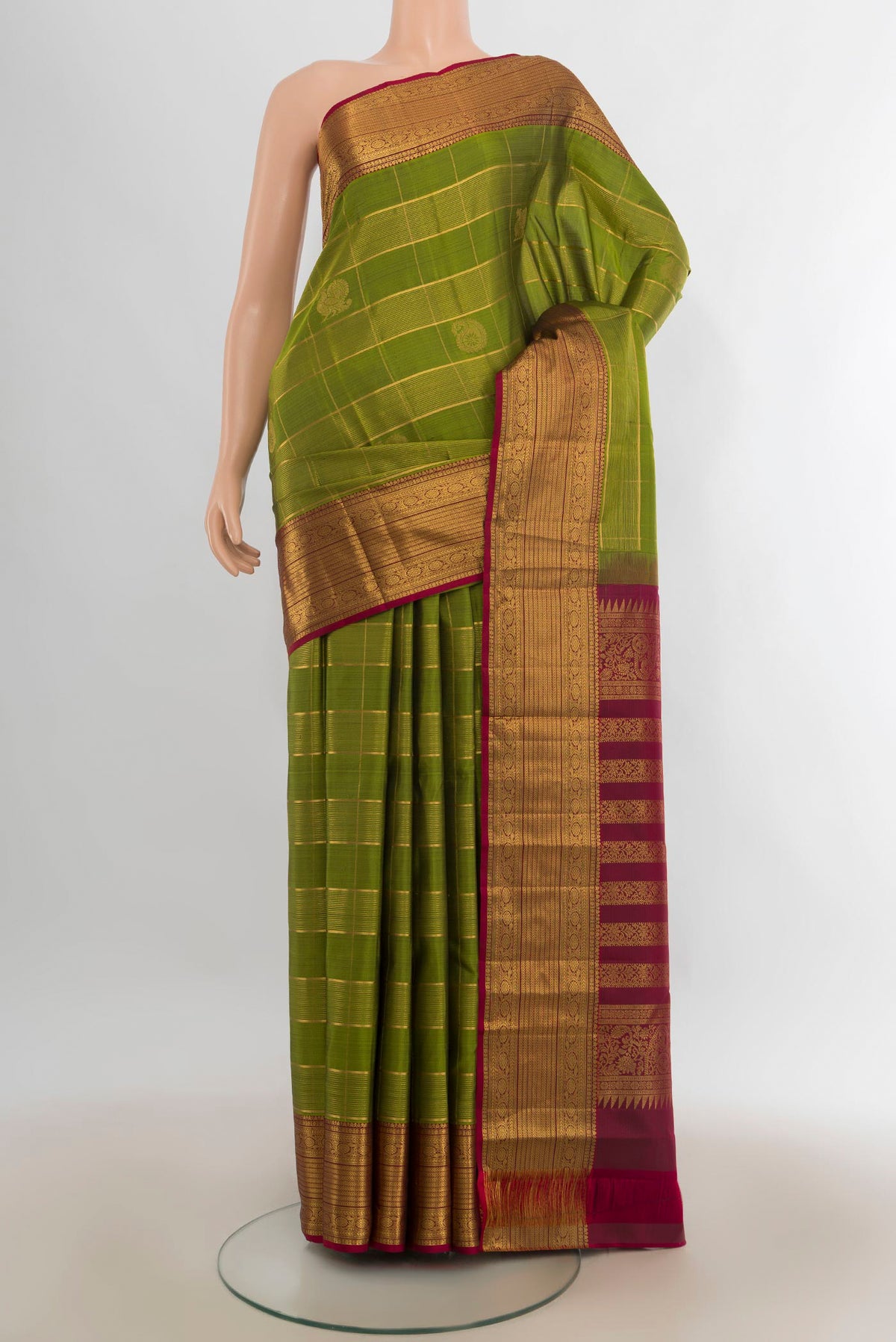 Pure Silk Mehandi Green Kanjivaram Saree with Checked design on the body and Zari Border.  displayed on a mannequin