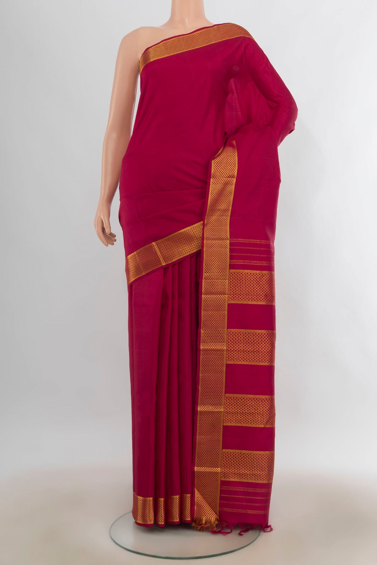 Pure Silk Maroon Kanjivaram Saree with Plain Body and Zari Border.  displayed on a mannequin