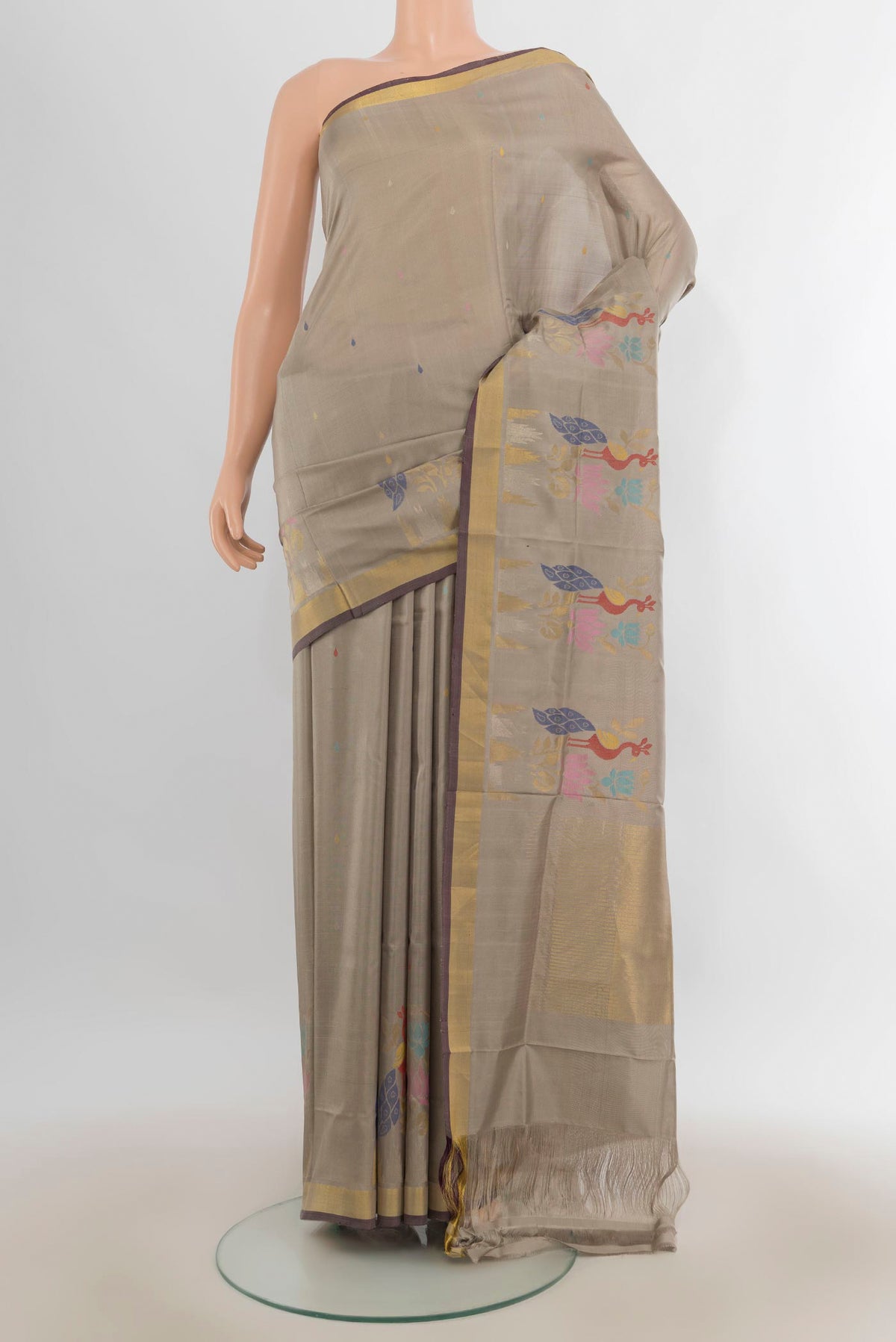 Pure Silk Grey Uppada Saree with Zari Butta on the body and Zari Border.  displayed on a mannequin